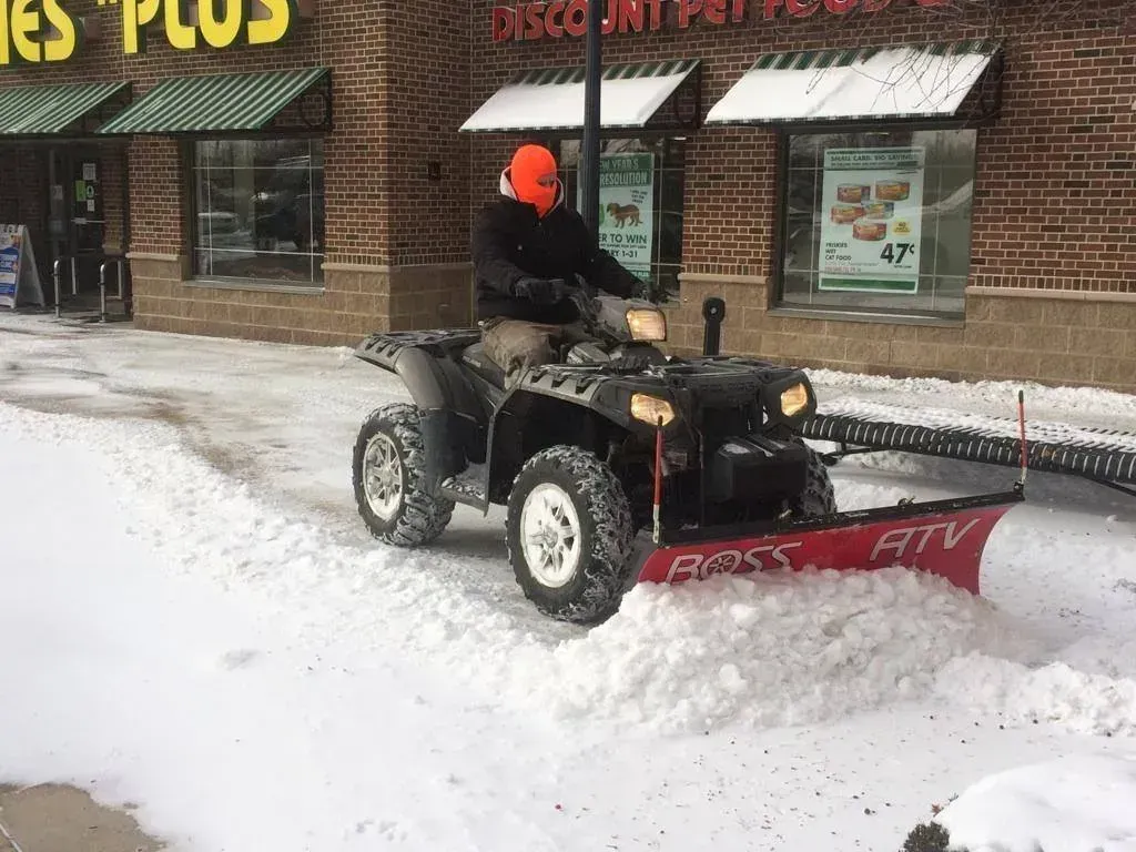 5 Points Landscaping crew plowing a commercial parking lot in Centerville, OH