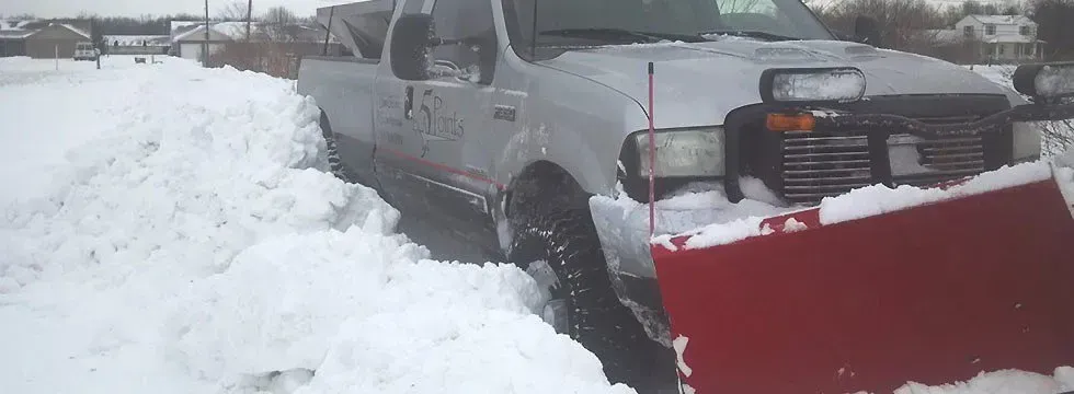 5 Points plow truck clearing snow from a driveway in Centerville, OH