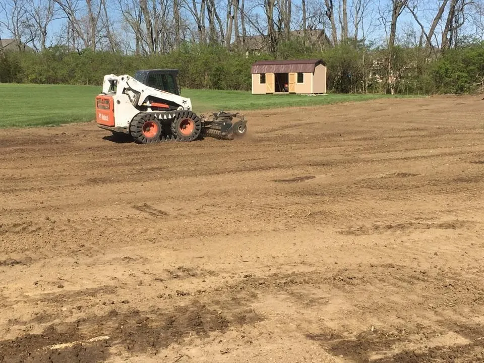 Bobcat skid-steer grading and leveling a large property in Centerville, Ohio