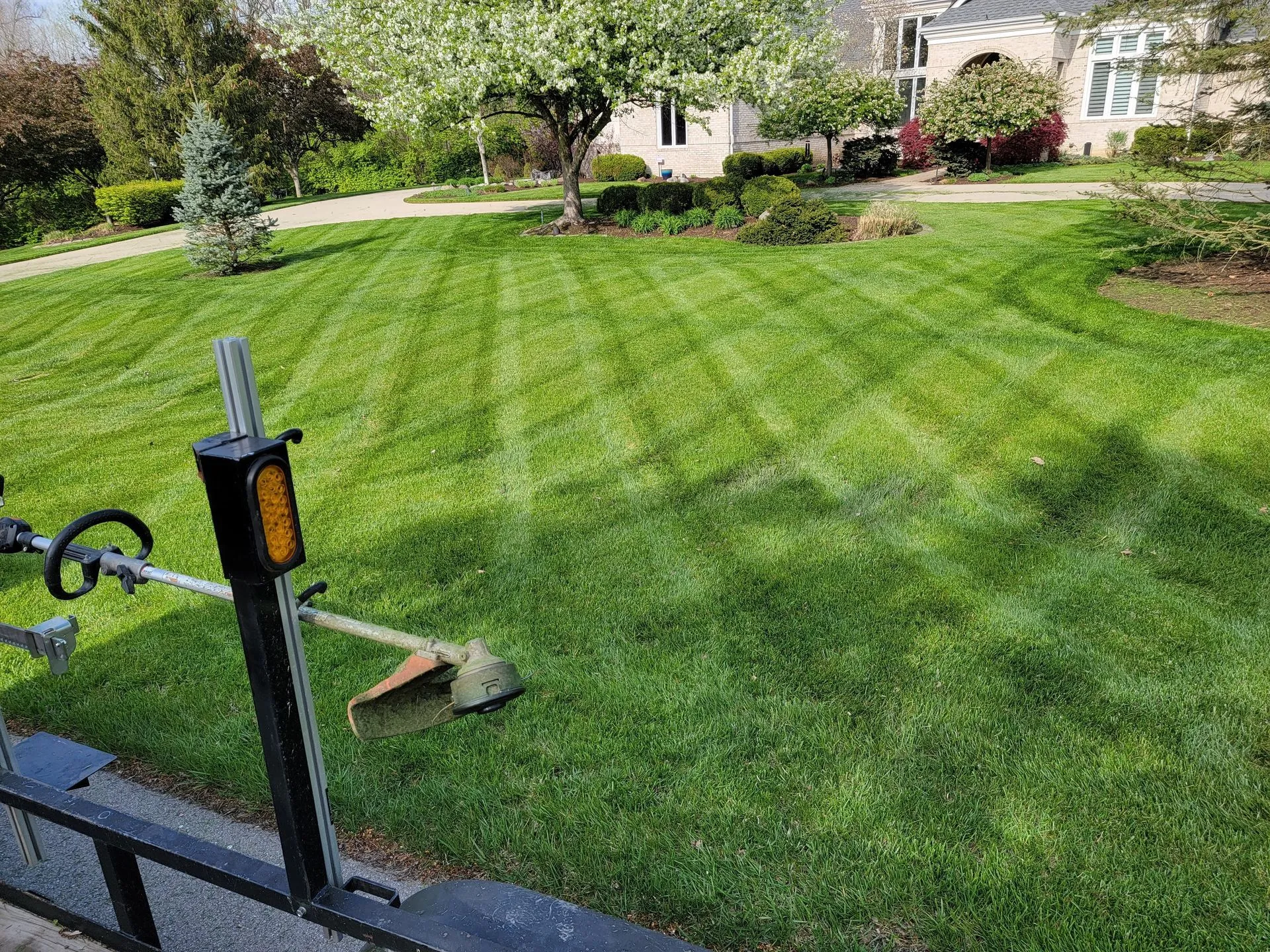 Freshly striped green lawn at a large property maintained by 5 Points