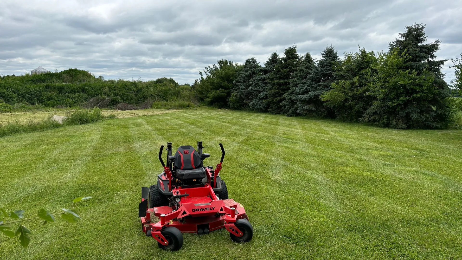 Zero-turn mower cutting a large field during brush hogging