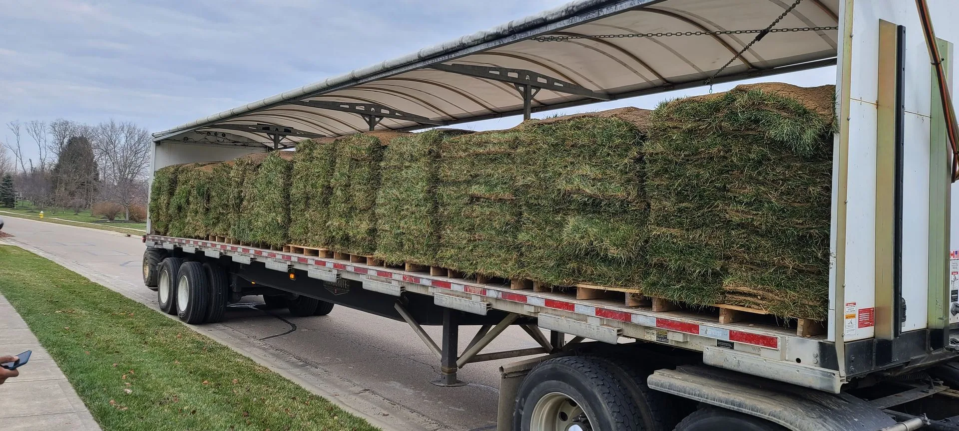 Fresh sod and materials delivered for a landscape installation project
